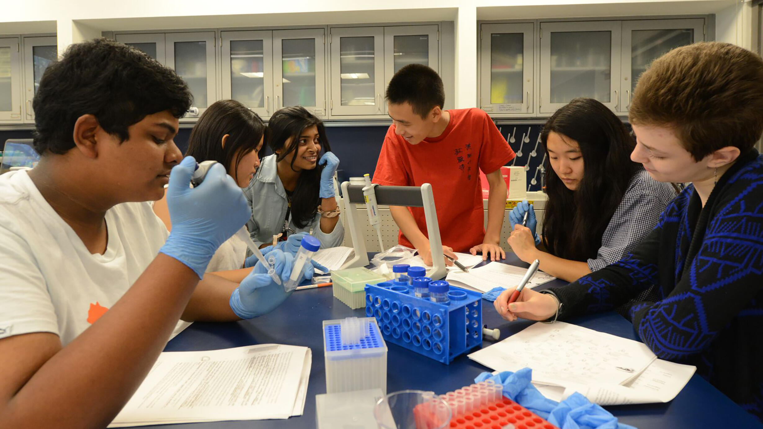 New York City High School students at lab table with DNA samples testing in an American Museum of Natural History classroom.