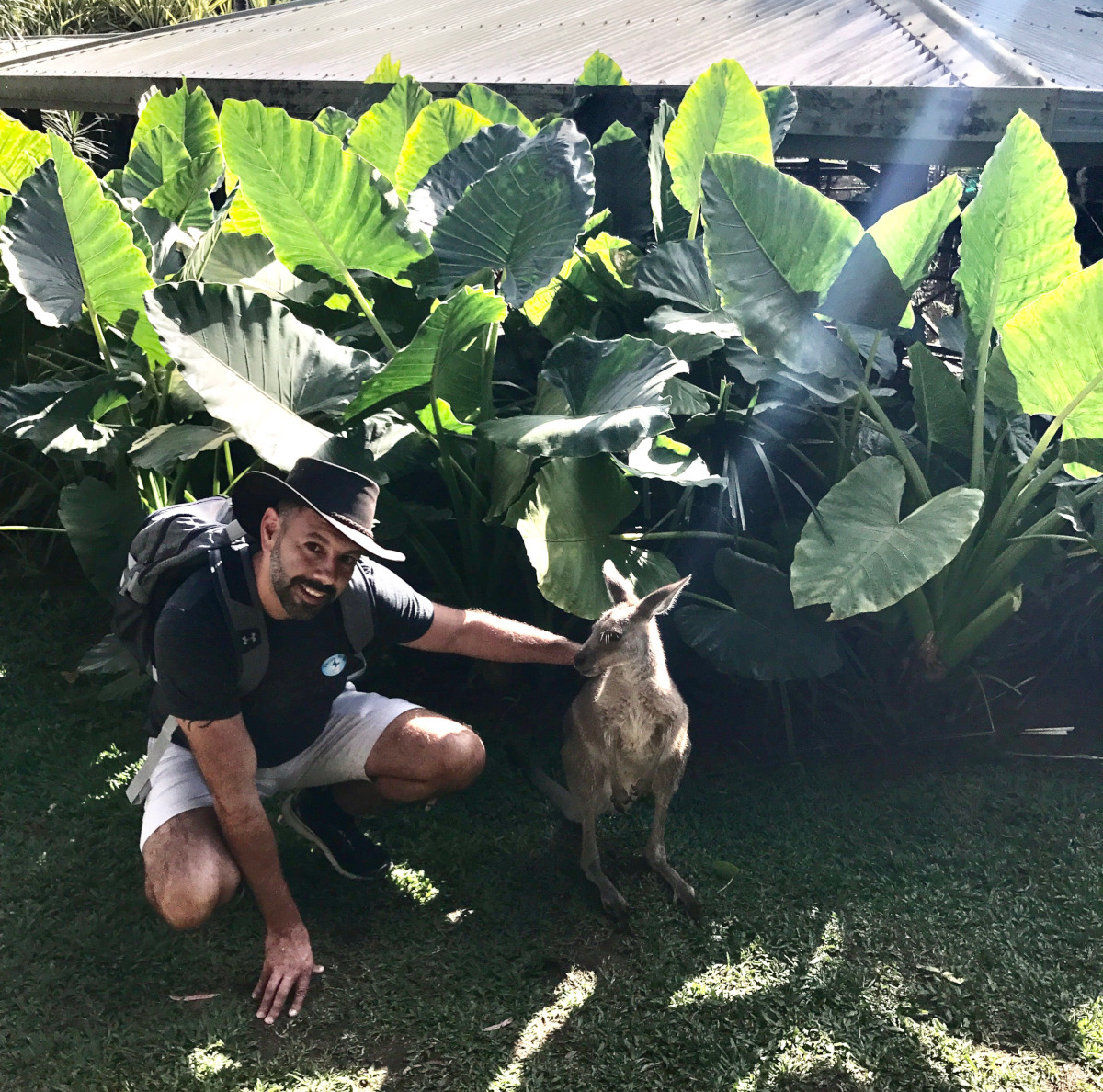 photo of Joseph Hernandez crouching beside a kangaroo