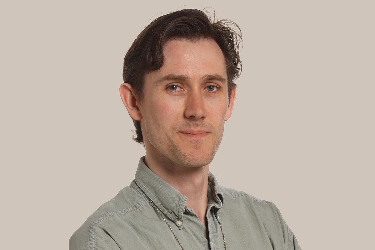Headshot of ichthyologist Ian Harrison who wears a button-up shirt.