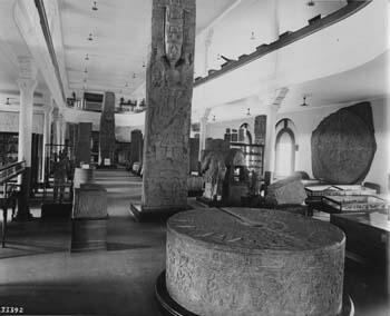 A Museum hall with enormous carved stone artifacts.