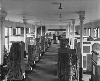 A museum hall containing rows of carved stone sculptures and tablets.