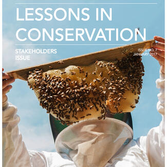 Cover of Lessons in Conservation, Issue No. 7 - Stakeholders Issue featuring photograph of beekeeper in a suit holding a hive in front of their face.