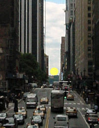 The full sun setting in alignment with Manhattan's street grid.