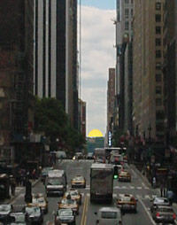 The half sun setting in alignment with Manhattan's street grid.