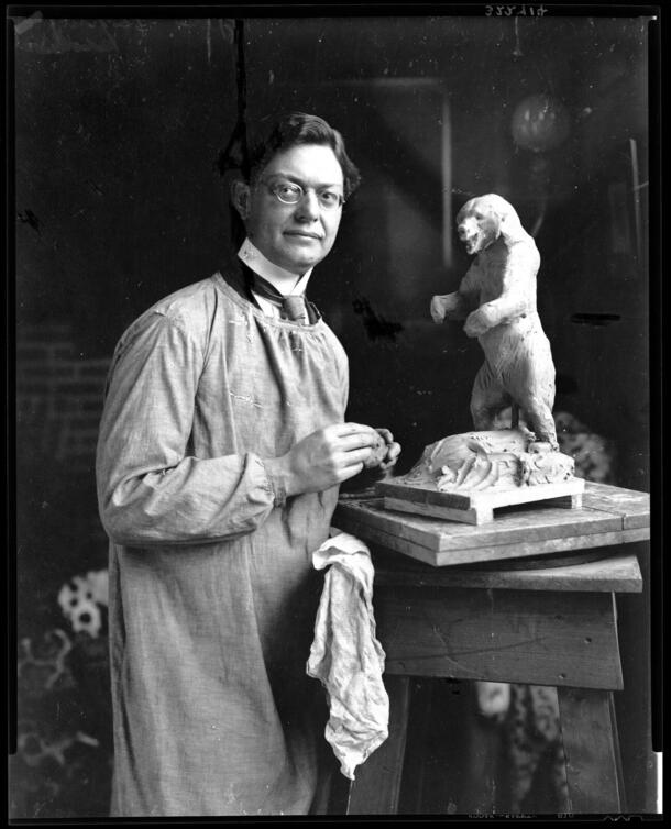 Charles R. Knight in his studio working on his sculpture Kodiak Bear at Bay.
