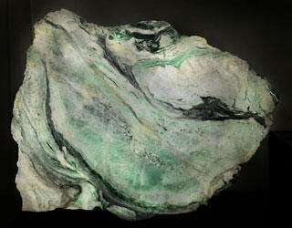 A jade specimen containing whorls of green and white.