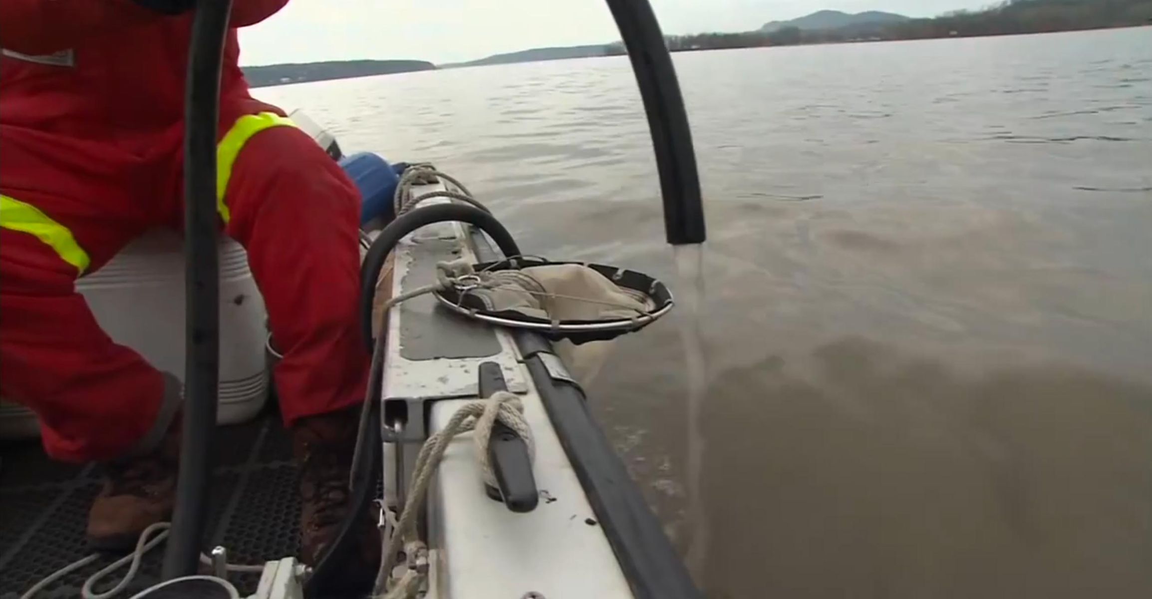 Scientist filtering river water from a boat