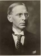 A black and white portrait of Berthold Laufer, born 1874, died 1934, shown wearing a jacket, necktie, and eyeglasses.