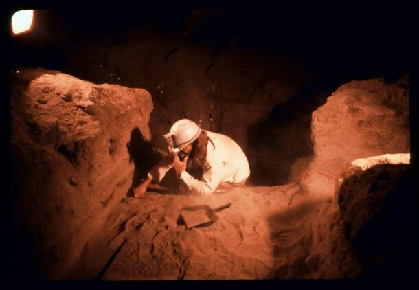 Helmeted researcher digging at Hidden Cave, Nevada