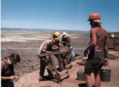 Group of people with archaeology equipment in Nevada desert.