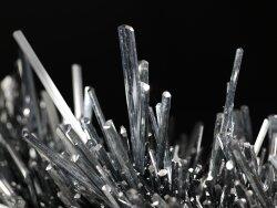 Sword-like crystals sprouting from rocky base, part of 1,000-pount mineral specimen in Grand Gallery