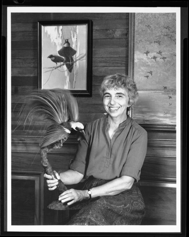 Portrait of ornithologist Mary LeCroy holding a bird specimen, photographed between 1989-1990