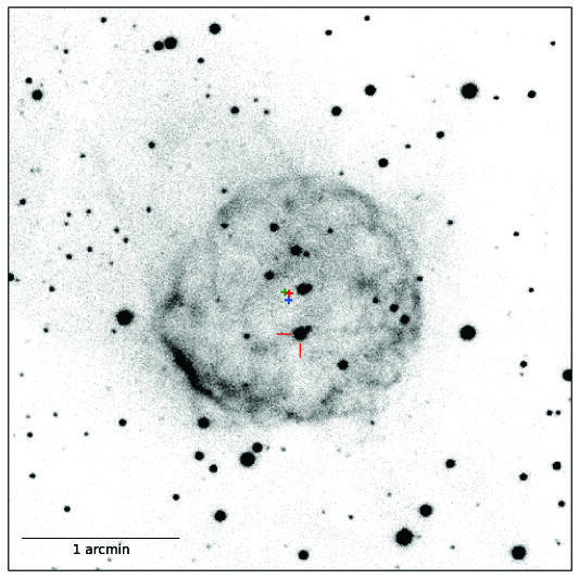 This square image has a number of scattered black spots distributed randomly with a grey circle in the center. A scale bar for 1 arcmin is below.