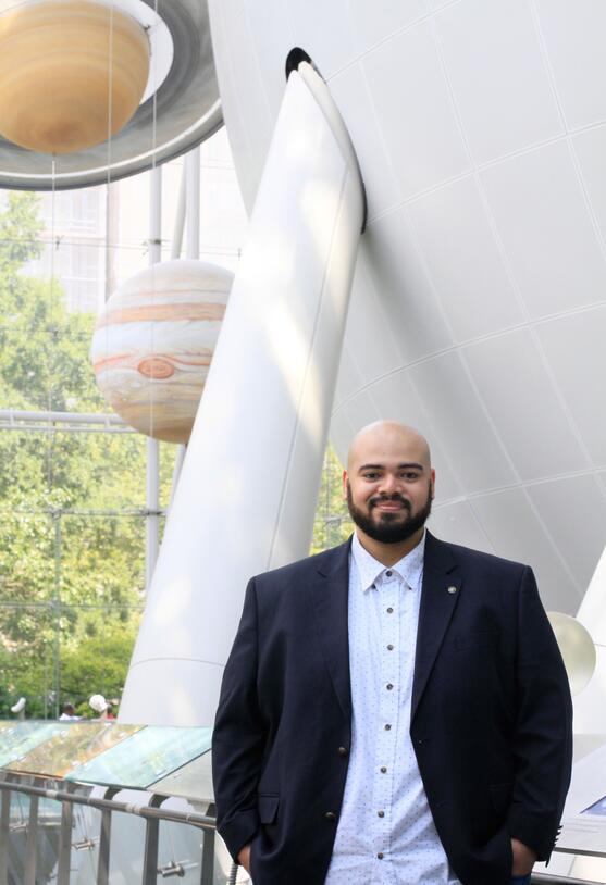 Dr. Dax Feliz in the American Museum of Natural History's Rose Center for Earth and Space. 