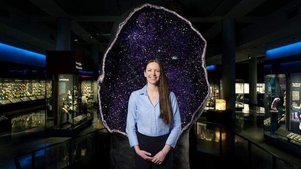 Dr. Kate Kiseeva in the American Museum of Natural History's Allison and Roberto Mignones Hall of Gems and Minerals.
