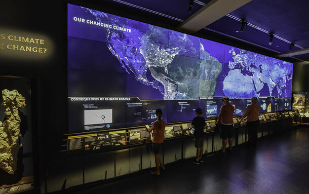 Visitors in the Museum's Hall of Planet Earth interact with digital displays that are all about climate change.
