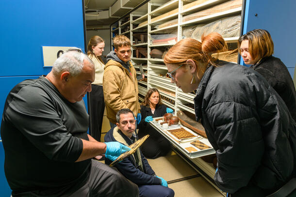 Members of the Hawaiian delegation view items in the Museum’s Pacific ethnographic collection, including examples of basketry accessioned in 1900. 
