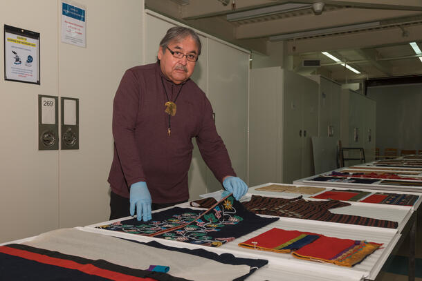Mr. David Grignon reviews a collection of Menominee textiles in the Division of Anthropology