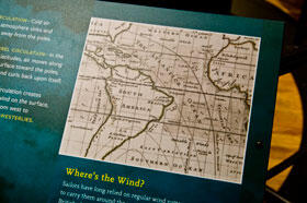 Small map on museum exhibition explanation panel shows South America, southeastern North America, the Atlantic Ocean, and northwestern Africa.