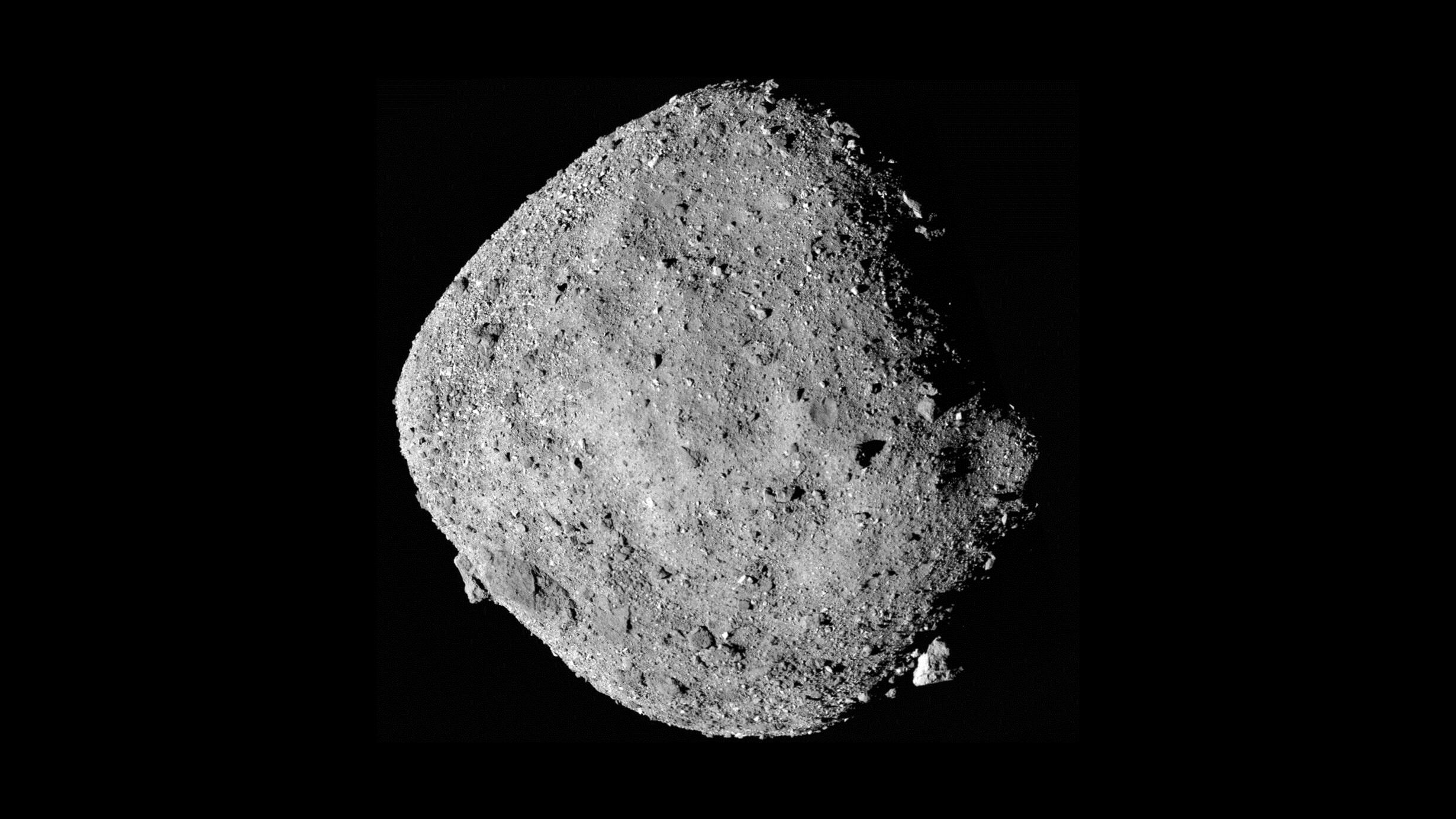 A closeup photograph of the Bennu asteroid, taken by NASA's OSIRIS-REx spacecraft. Bennu is rocky, with a roughly spheroidal shape.