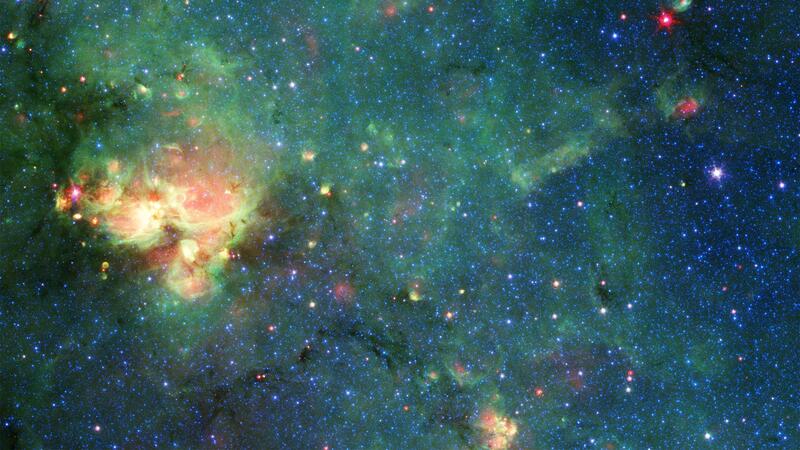 An image of the so-called nebula - a cloud of gas and dust in space. Thousands of bright stars stand out against a deep, rich wash of hues.