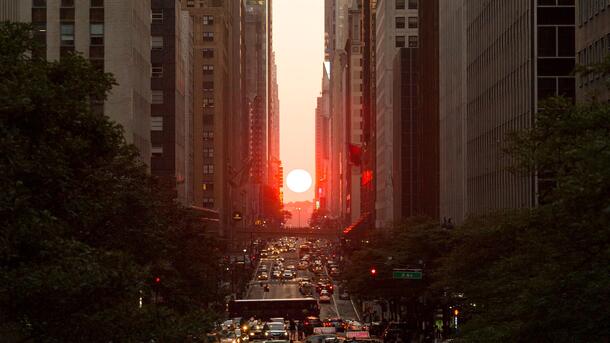 The setting sun, seen perfectly framed by the city street grid while facing west in New York City - a twice-annual occurrence known as Manhattanhenge.