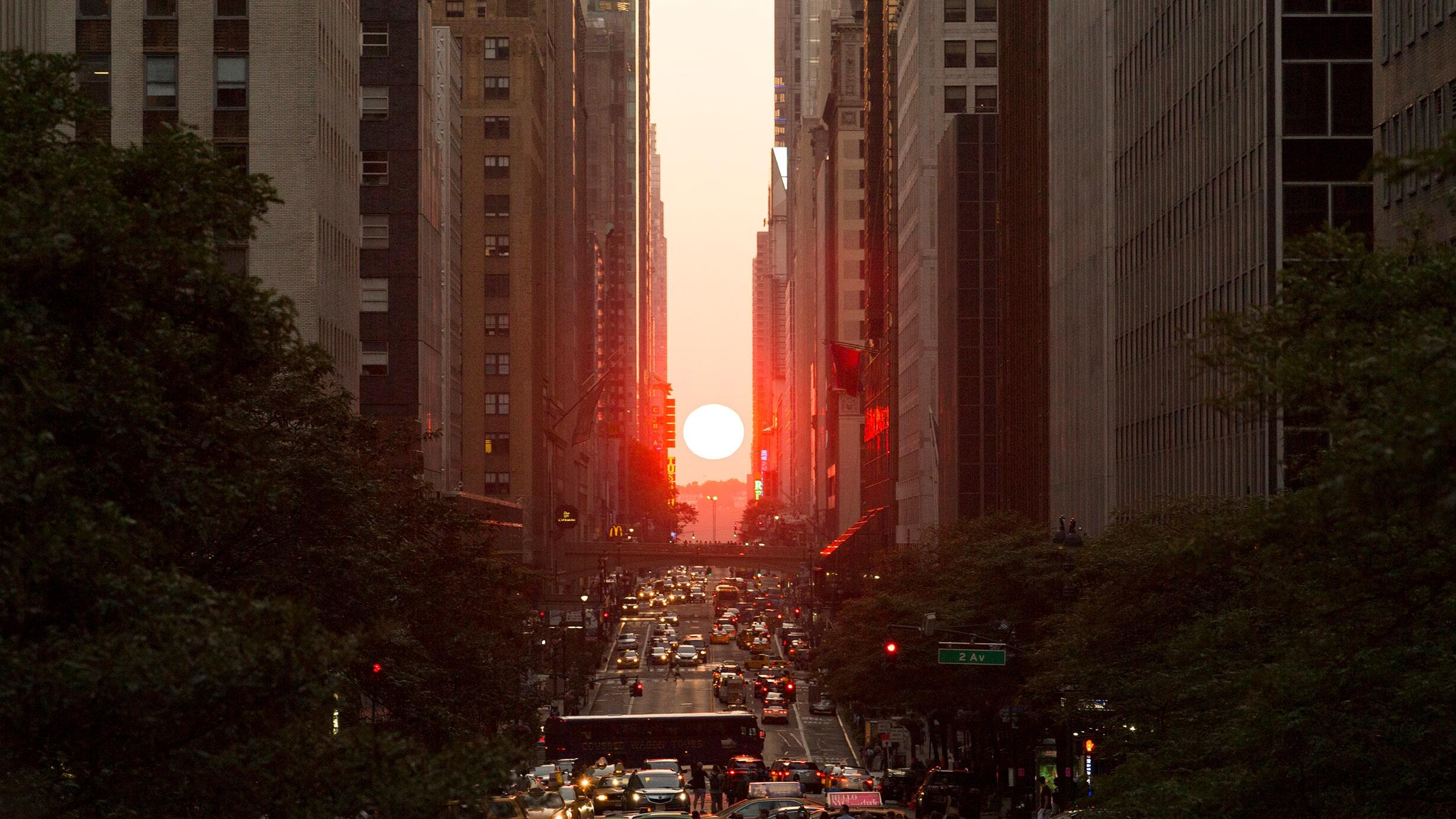 The setting sun, seen perfectly framed by the city street grid while facing west in New York City - a twice-annual occurrence known as Manhattanhenge.
