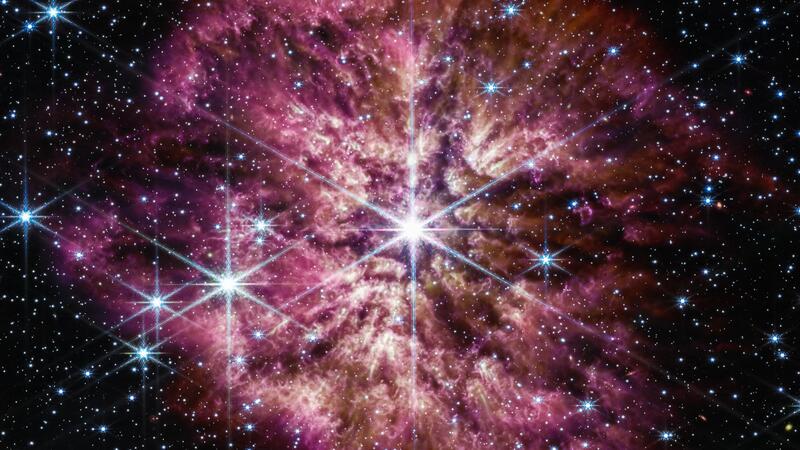 The hot star Wolf-Rayet 124, seen as a bright white star against a dark, milky background, seen in infrared and near-infrared by the Webb telescope.