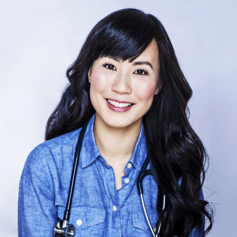 Smiling headshot of Dr. Melissa Lem wearing a stethoscope around her neck and posed in front of a plain backdrop.