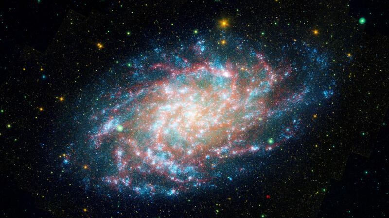 An image of galaxy NGC598, more commonly known as M33. Brilliant white stars glow in a spiral formation against a backdrop of black space.