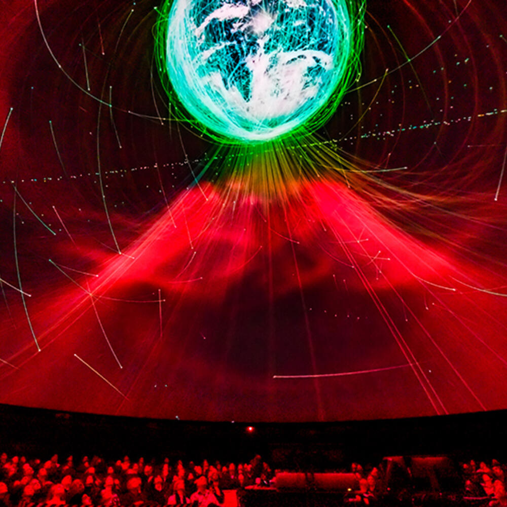 Seated visitors view the Space Show on a 360 degree screen inside the Hayden Planetarium.