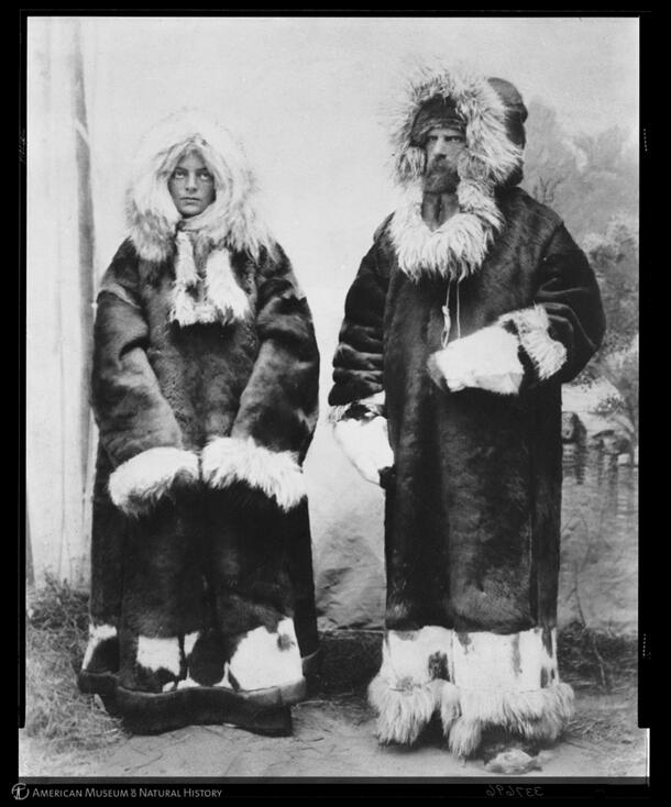Dina Jochelson-Brodskaya (left) and Waldemar Jochelson (right) stand side by side dressed in thick, hooded fur coats.