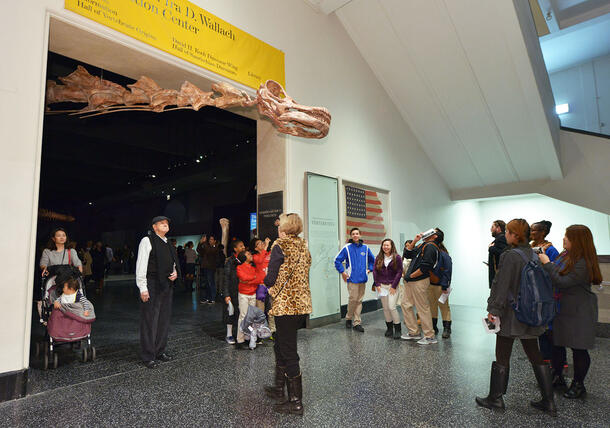 The Titanosaur's head extends out of the Wallach Orientation Center's entrance, looming over approaching visitors.