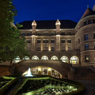 Nighttime view of the the 77th street entrance to the American Museum of Natural History.