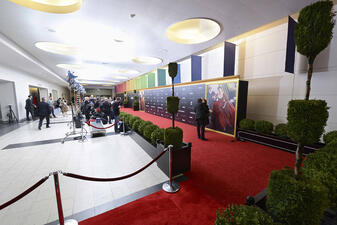 Red carpet and velvet ropes in use for an event in the school reception area of the American Museum of Natural History.