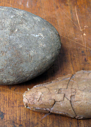 Two ovoid rock-like specimens on a flat surface