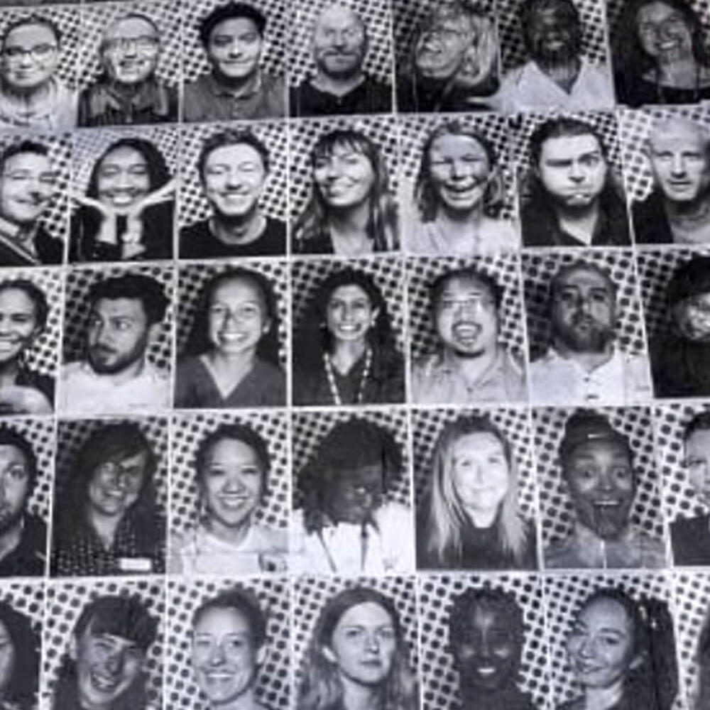 Multiple rows of larger-than-life portraits.