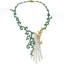 Emerald and diamond necklace with curved, branchlike cord design and a cascade of diamonds and small diamond butterflies at the neckline.