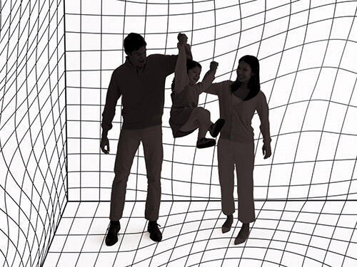 Two adults swing a child between them in a room where the walls and floor are covered in a wavy, gridded pattern meant to create an optical illusion of movement.