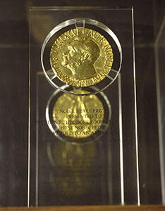 The Nobel Peace Prize, comprised of a gold medal embedded in a lucite plaque.