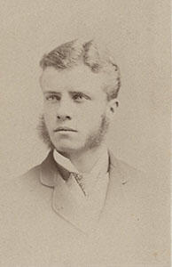 A portrait of college-aged Theodore Roosevelt, in which he sports thick sideburns.