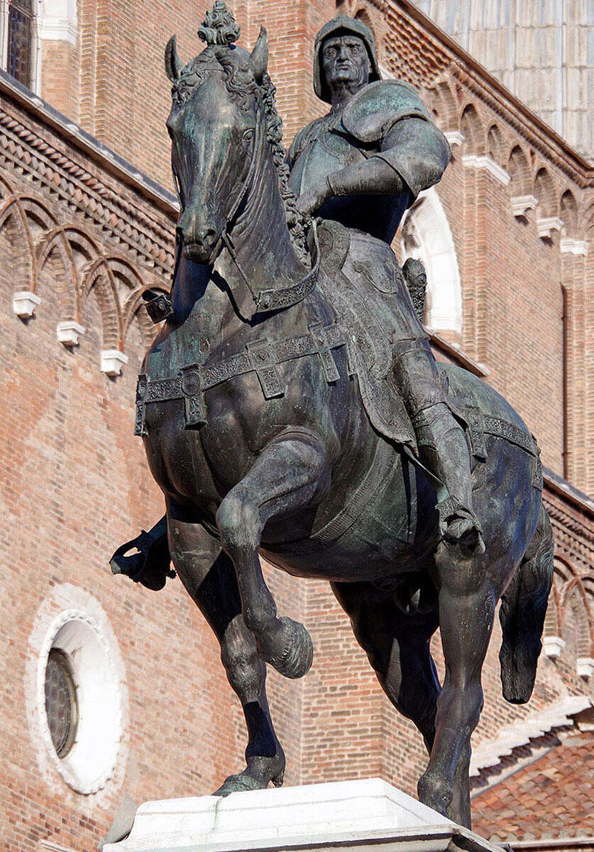 Equestrian statue with one rider dressed in military garb.
