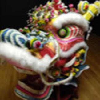 A colorful elaborate object representing the head of a fantastic creature.