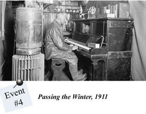 A black and white photograph of a man seated at an upright piano.