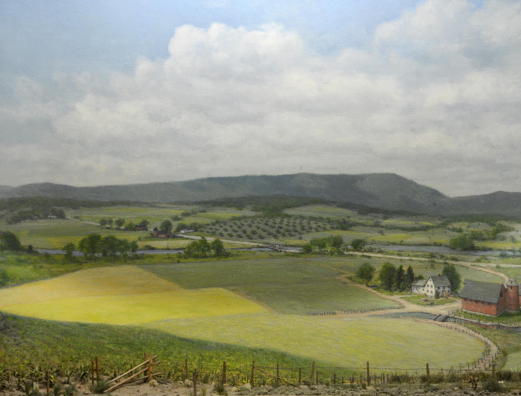 Diorama of a field and a farm in showing green fields. 