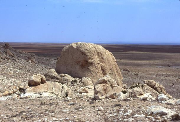 Big formation of limestone on a very arid area with a blue sky.