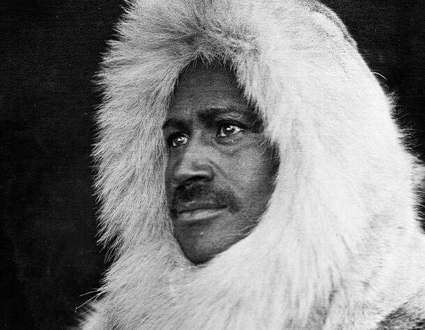 Portrait of Matthew Henson wearing a fur hood.