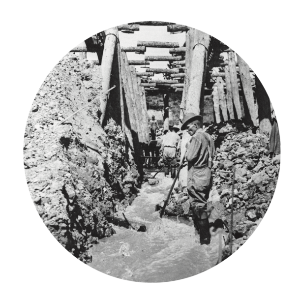 Miner dressed in work clothes walks towards the entrance of a sapphire mine.