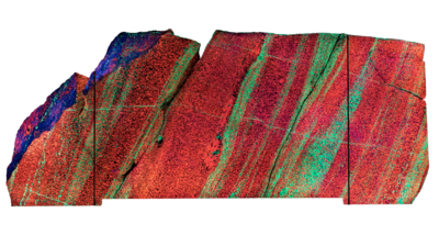 A multicolored slab of rock with bright stripes of color on its surface.