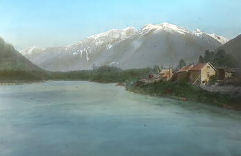 River with snow-capped mountain in the background, trees at the base and along coast, and a few wooden buildings along the coast on the right side. 